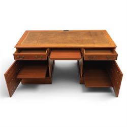 Georgian design yew wood twin pedestal office desk, the top featuring an inset leather writing surface, with drawer drawers and centre keyboard slide, all above two cupboards with slide out shelves
