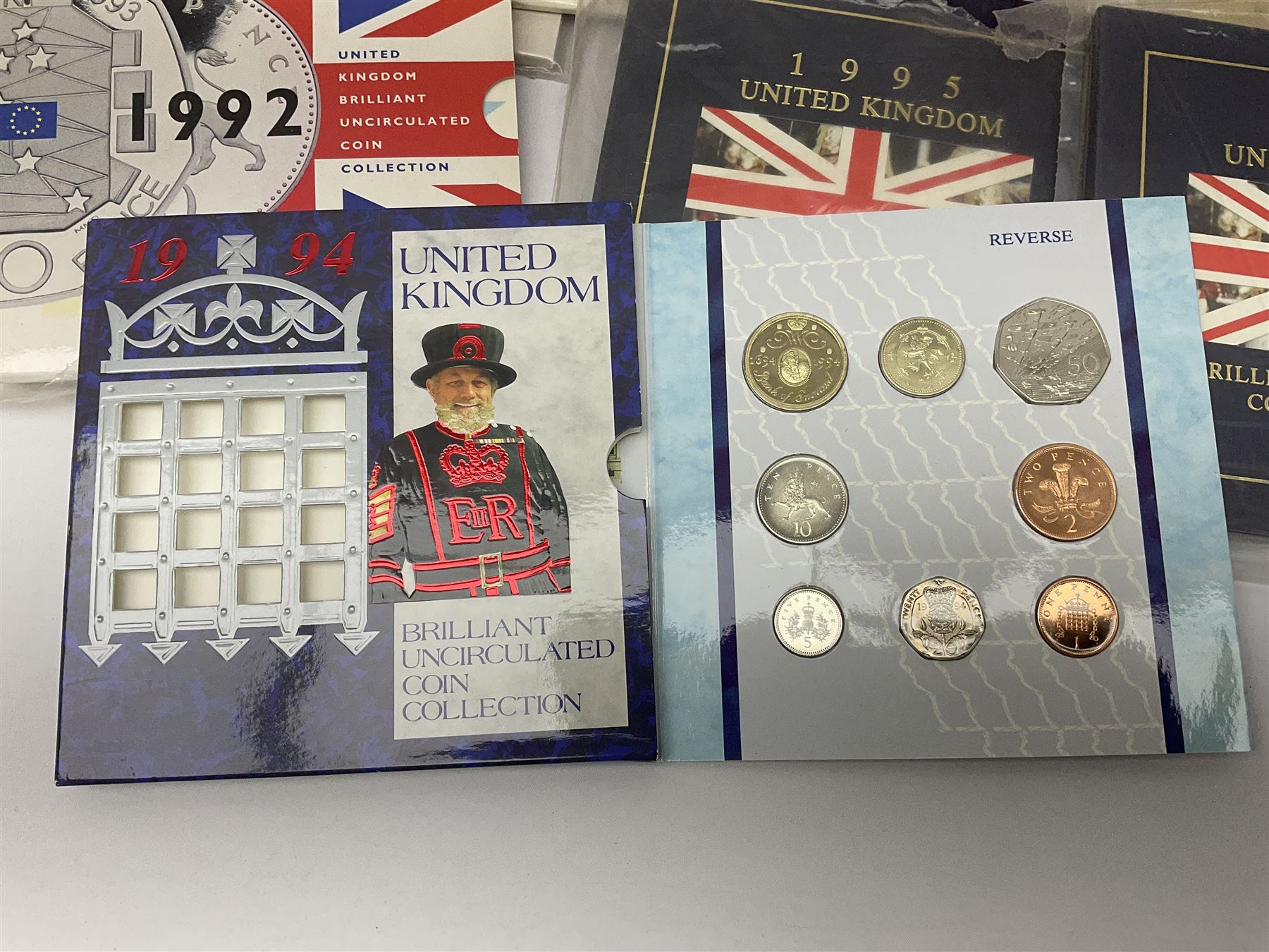 Fourteen Queen Elizabeth II United Kingdom uncirculated coin collections, dated 1983, 1984, two 1985, 1986, 1987, 1988, 1989, 1990, 1991, 1992 including dual dated 1992/1993 EEC fifty pence, 1994 and two 1995, all in card folders