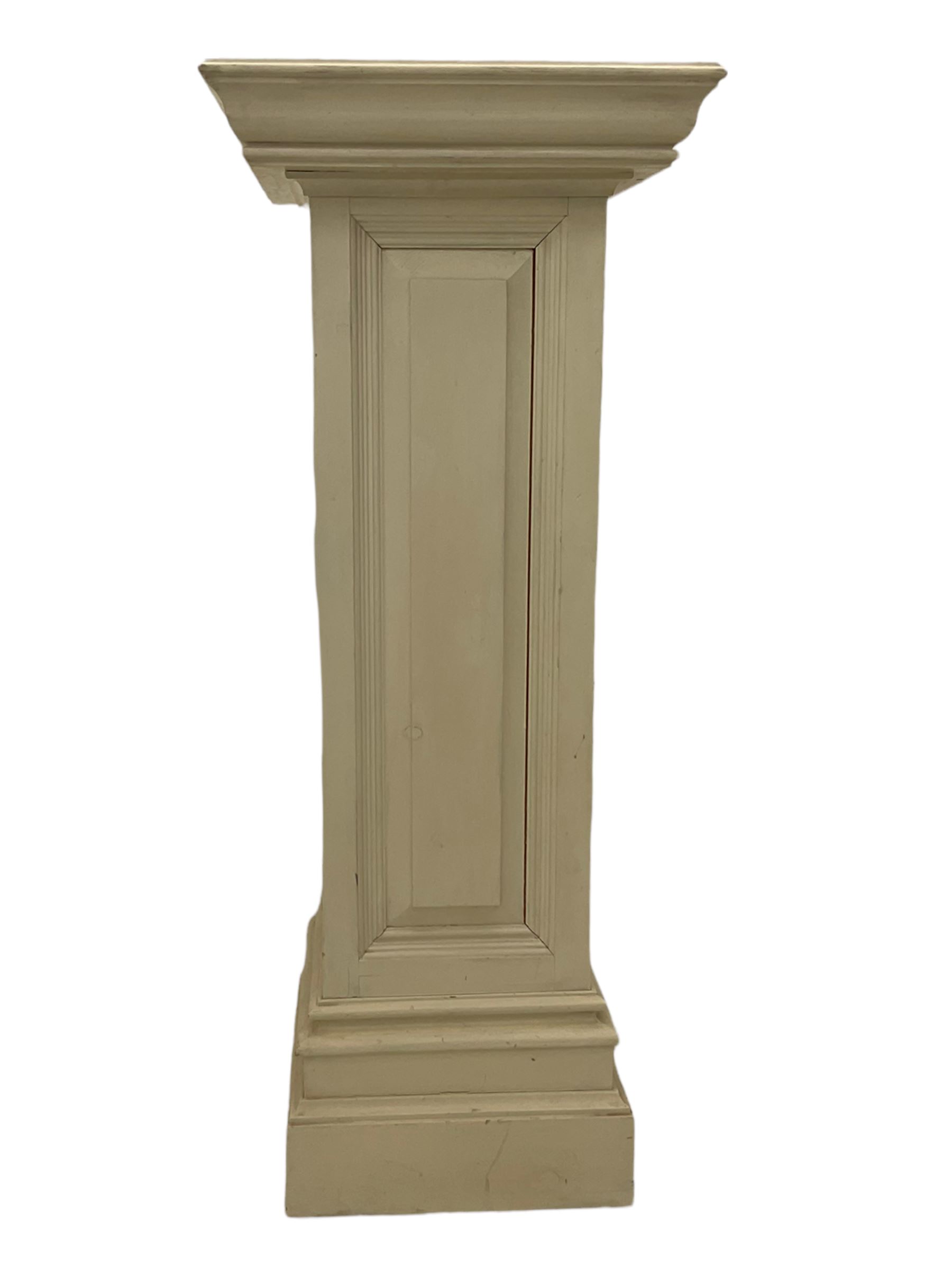 White painted pine pedestal plinth, the square moulded top over panelled rectangular body, stepped and moulded plinth base
