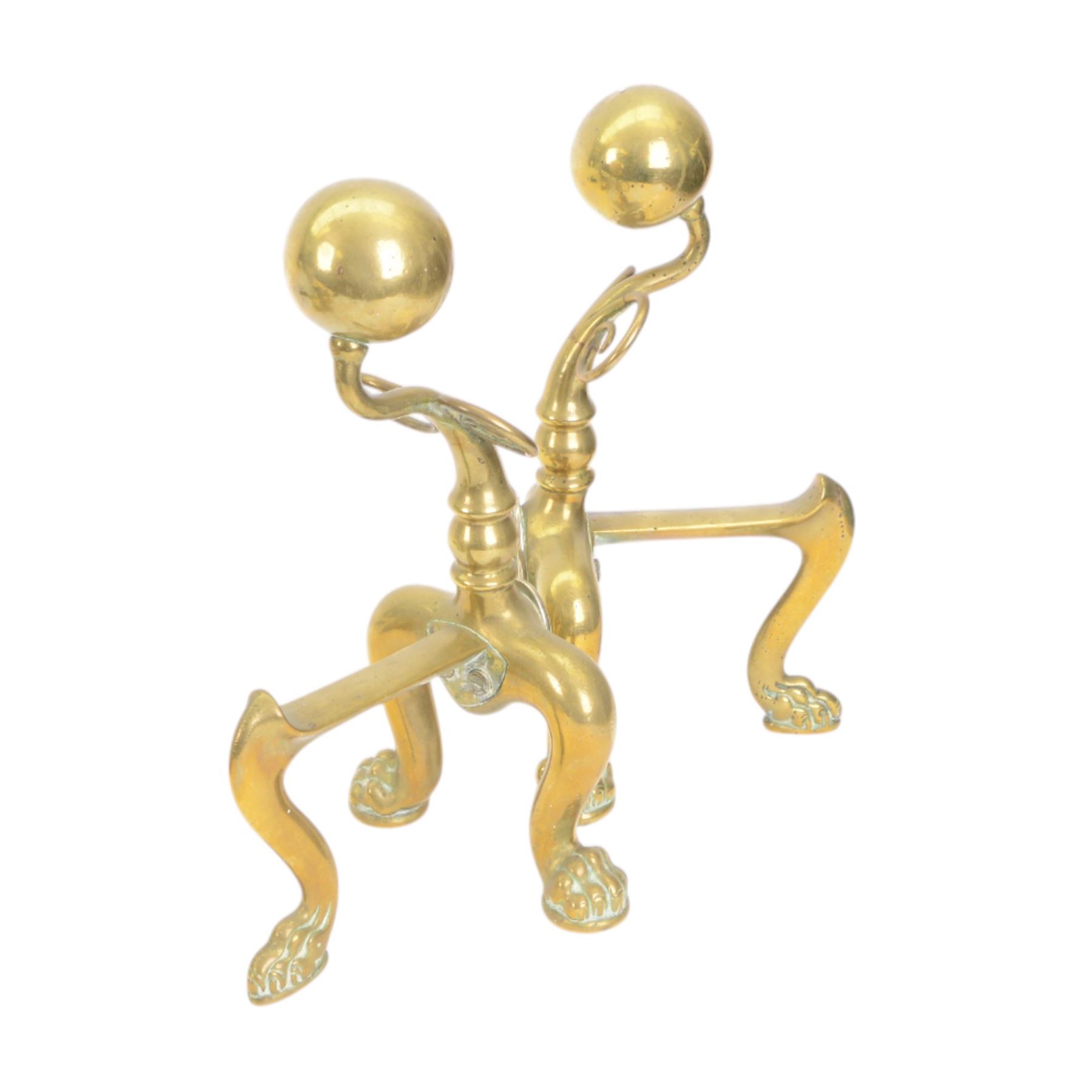 Pair of  Victorian brass fire dogs, decorative brass ball roundels to tops, with a silvered cartouche to the front, raised upon paw feet, together with two other fire dogs, largest H36cm 
