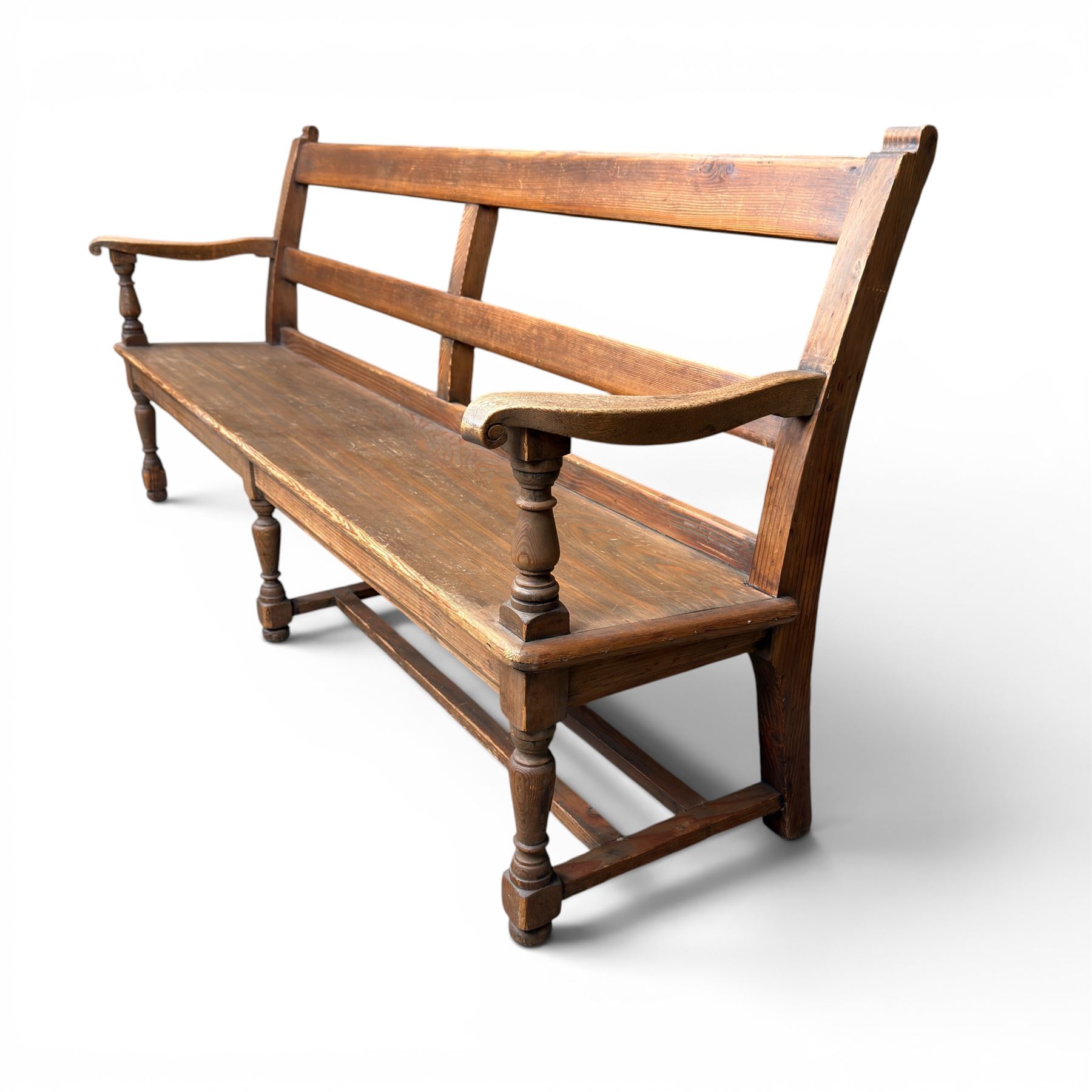 Early 20th century pine and oak bench seat, stained pine rail back frame with shaped oak arms
