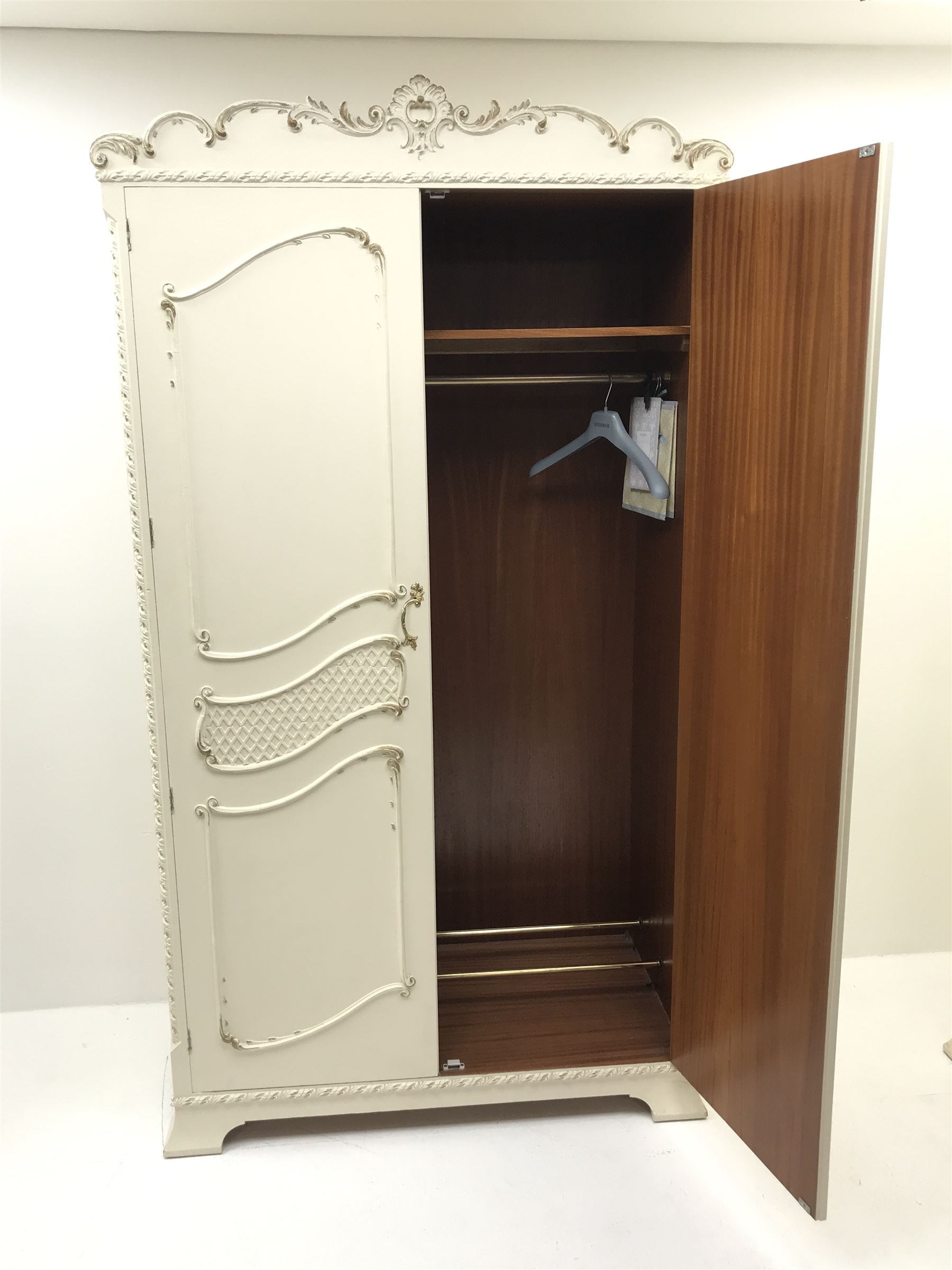 Late 20th century French style white and gilt double wardrobe,  shell carved cresting rail, two doors enclosing fitted interior, shaped bracket supports