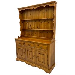 Pine farmhouse dresser with three drawers and three cupboards, and two tier plate rack