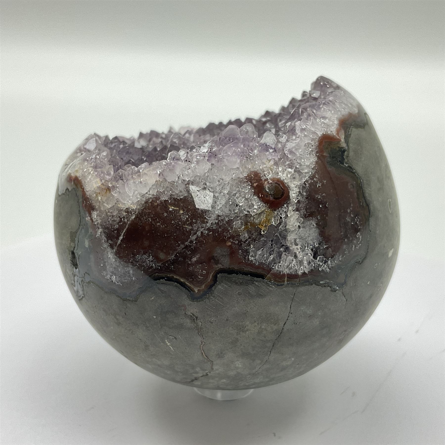 Pair of amethyst geode spheres, with purple crystalline internal formations, D9cm