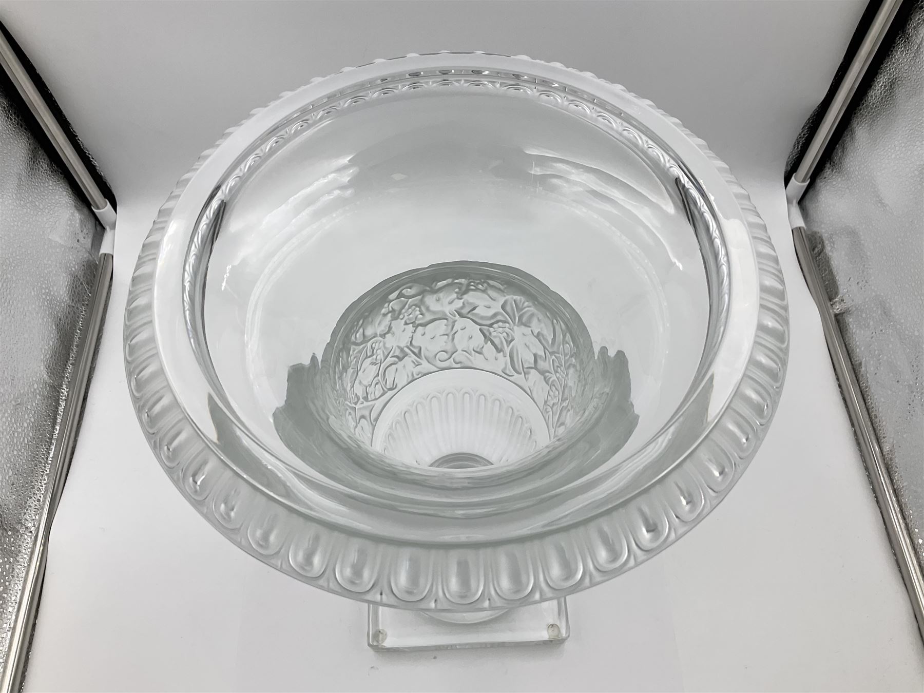 Large and impressive Lalique Versailles pattern glass vase, of classical baluster form with gadrooned flared rim, the body moulded in relief with fruiting vines above part fluting, upon a spreading circular foot with moulded decoration, and plain square plinth base, signed Lalique France to side of plinth, overall H35cm, with original box 