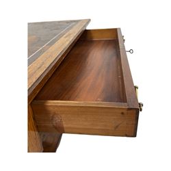 Late Victorian walnut writing table, rectangular leather-inset top surmounted by a brass gallery, fitted with a single frieze drawer, raised on turned tapering supports with lower undertier and ceramic castors