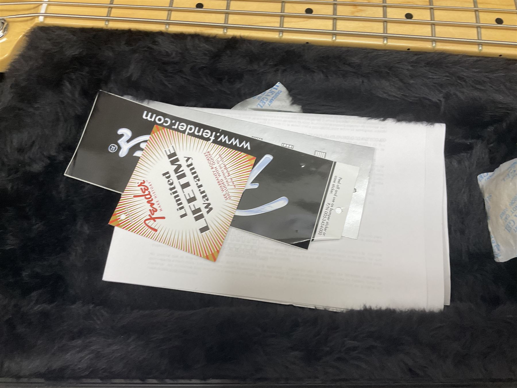 Fender Precision Bass guitar, in Olympic White finish with tortoiseshell effect scratchboard, serial no US15103092, in black Fender hard case with Fender strap and warranty card, guitar L116cm