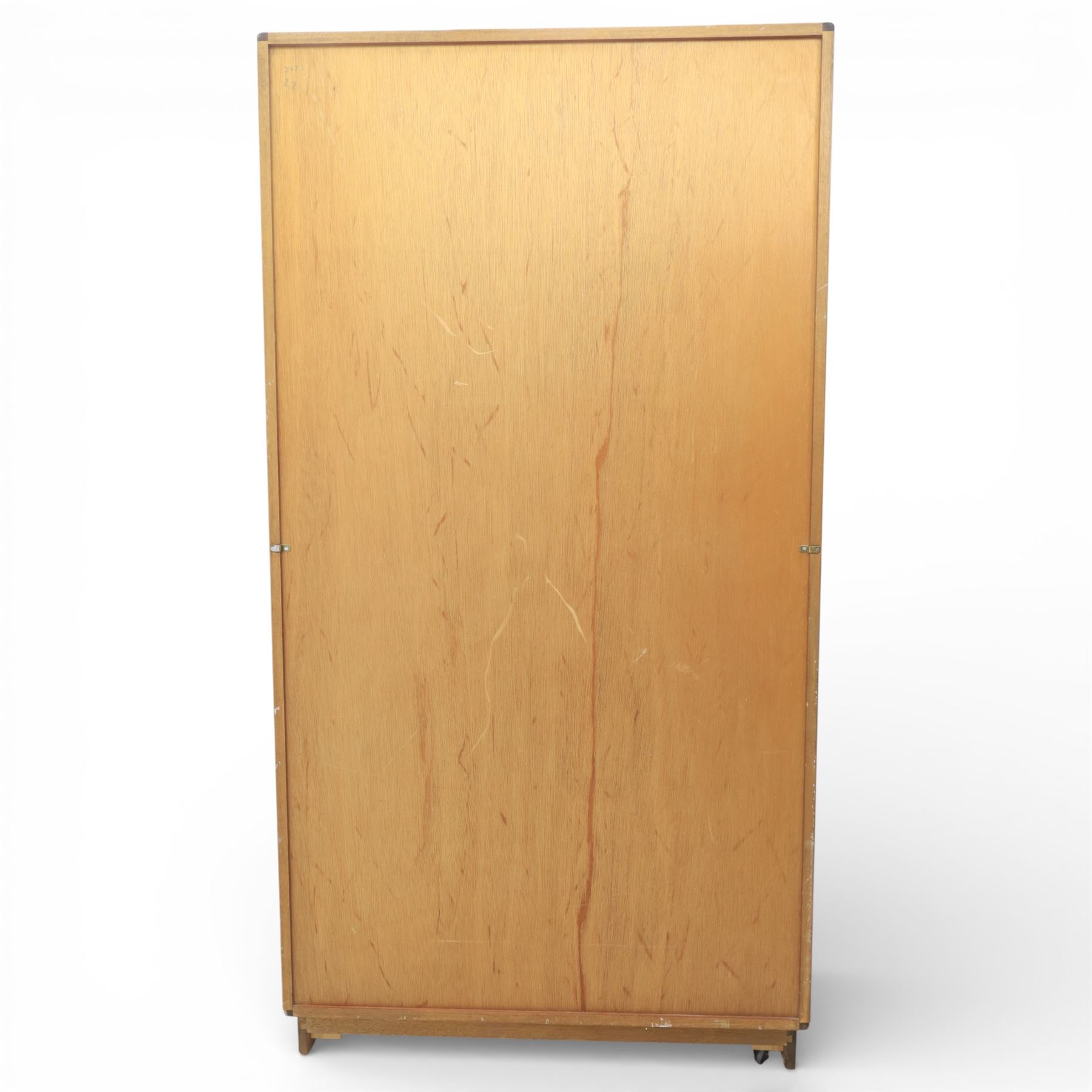 G Plan - 'Fresco' teak double wardrobe, twin doors enclosing a single clothes rail, on a recessed plinth base with castors beneath  