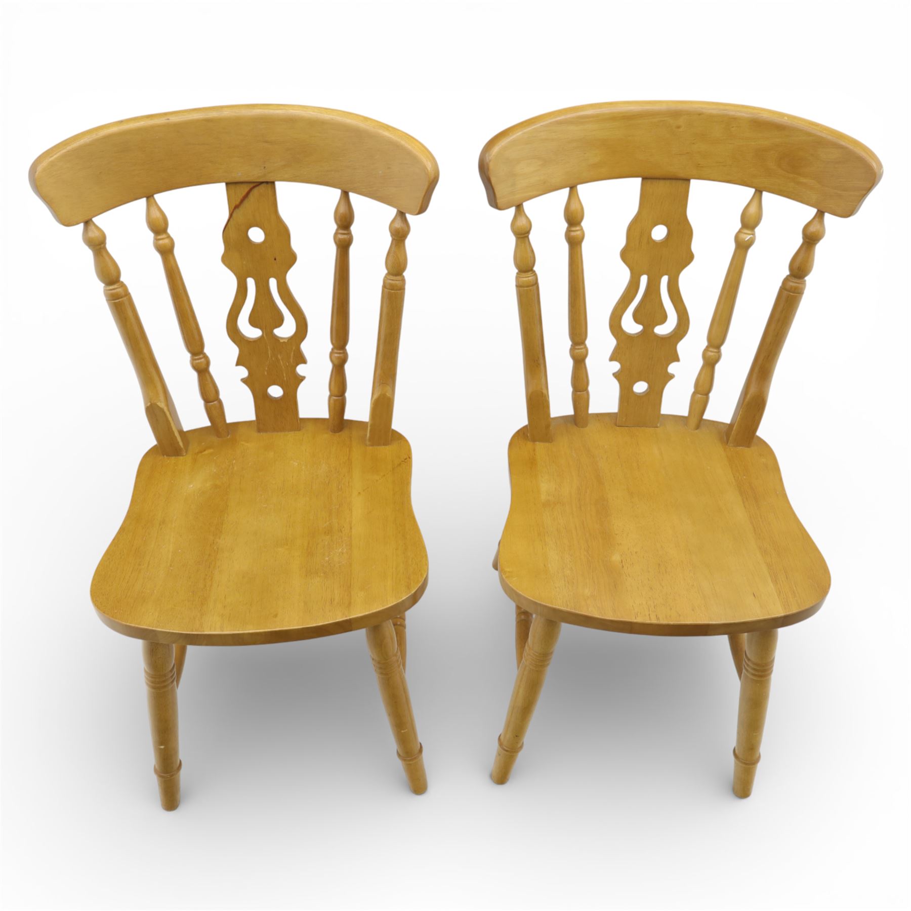 Solid oak dining table and set of seven pine farmhouse chairs including two carvers, rectangular top with tongue and groove style finish, supported a 'H' stretcher with square chamfered legs, pine farmhouse chairs with central splat and turned legs