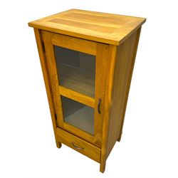 Laura Ashley - contemporary Milton oak display cabinet, featuring single door with two glass panels and pewter effect handle, enclosing one fixed oak shelf and two adjustable glass shelves, access hole at the bottom shelf, over single drawer with matching handle, on square legs