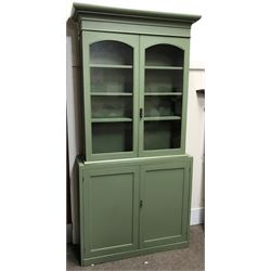 19th century and later painted pine cupboard, projecting cornice, two glazed doors enclosing three shelves, above two cupboards