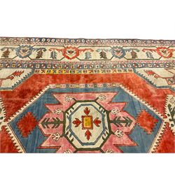 Anatolian Turkish ivory ground carpet, the central geometric pole medallion within an amber field, the guarded border decorated with stylised plant motifs surrounded by bands of repeating flower heads