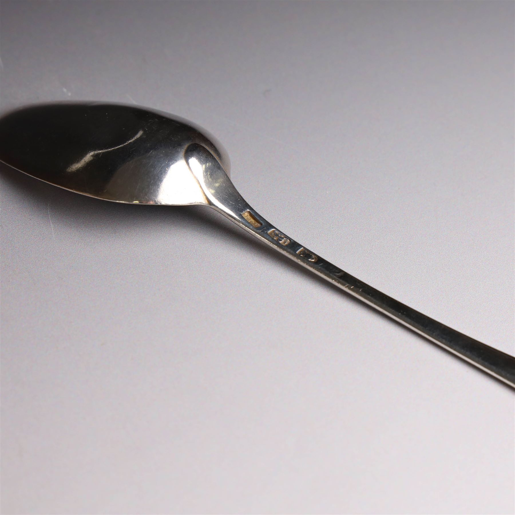 George II silver Old English pattern table spoon, with engraved initial W to terminal, hallmarked Thomas Northcote, London, probably 1758 date mark worn, together with a George III Old English pattern table spoon with bright cut decoration and engraved initials, hallmarked London 1783, makers mark TE probably for Thomas Evans
