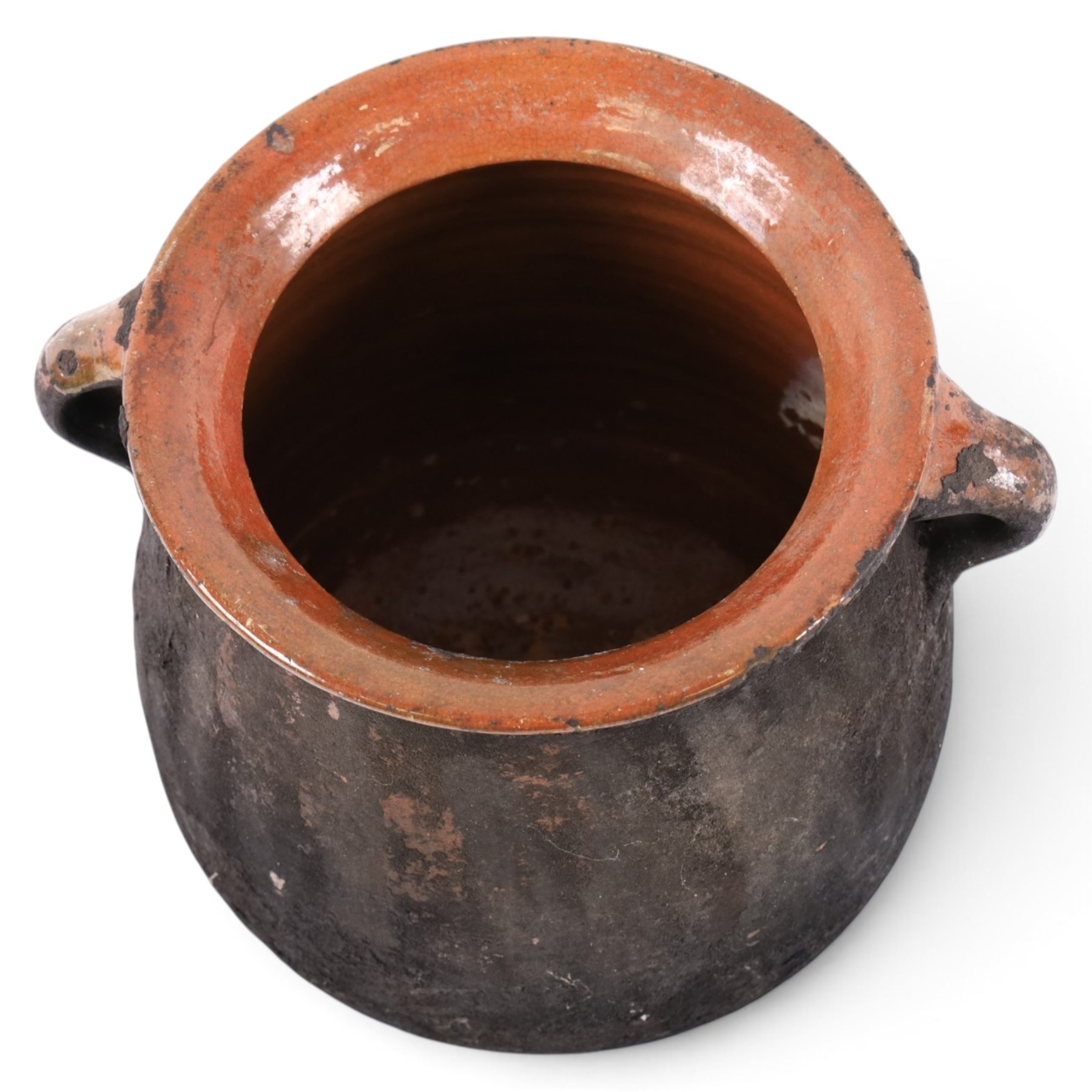 Spanish twin handled cooking pot, blackened to the outside, together with two bowls with slipware glaze, pot H22cm 