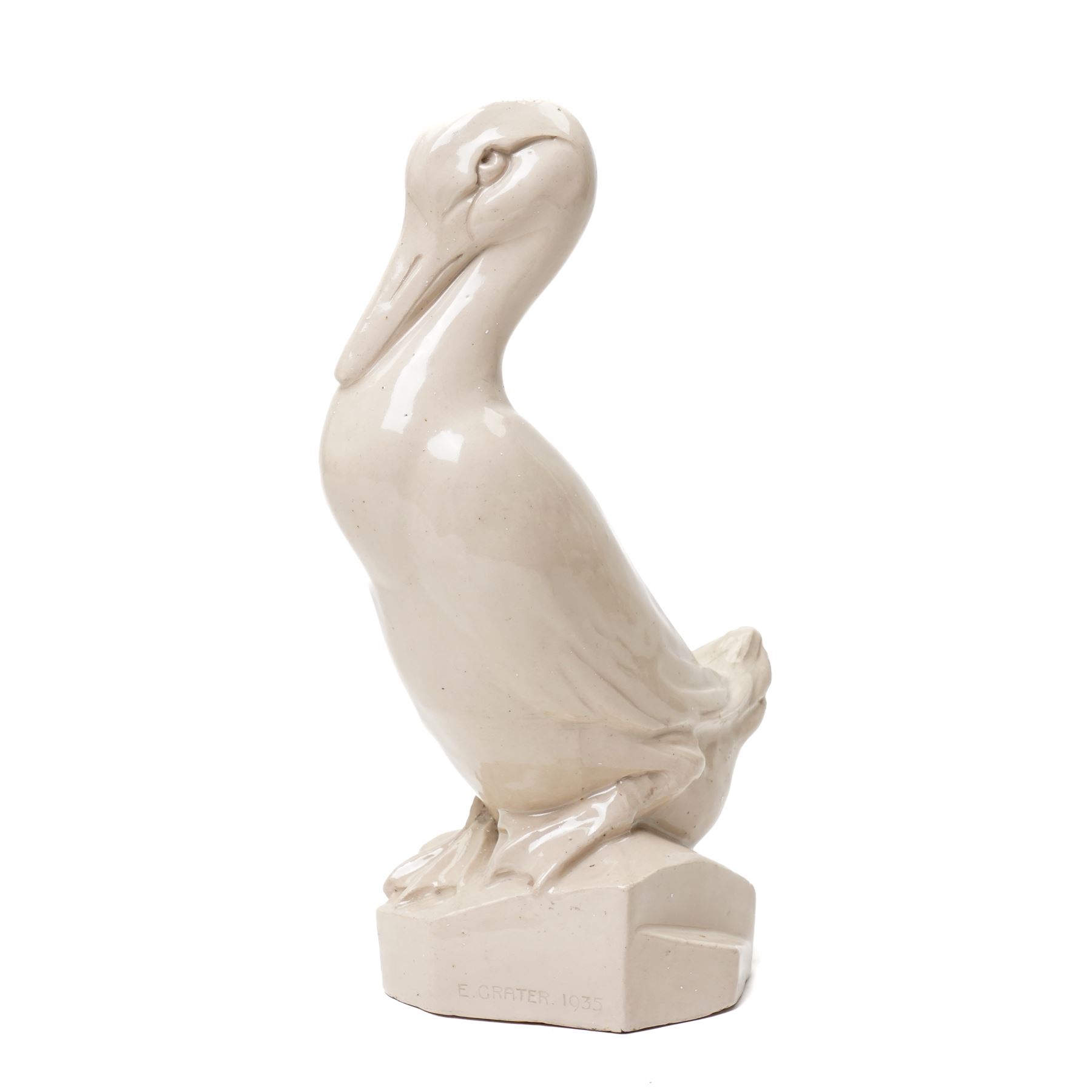 Early 20th century glazed figure of a duck perched upon a rock, signed 'E Grater' and dated 1935, H30cm 