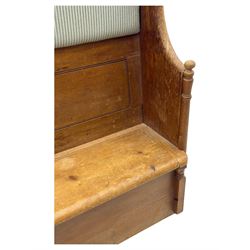 Early 20th century waxed pine pew, inset upholstered striped back panel with hinged box seat enclosing storage, shaped arms and turned supports