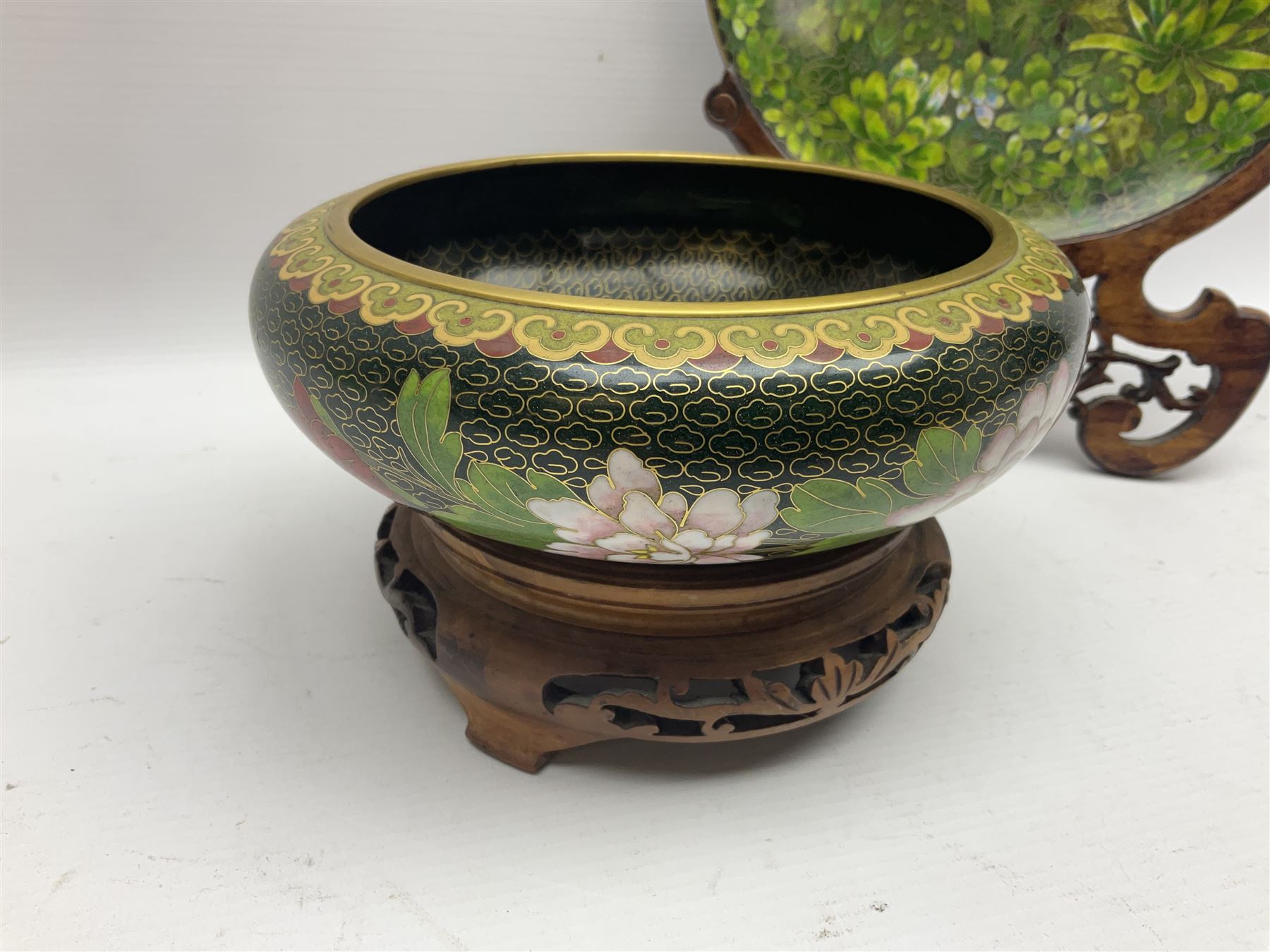 Pair of modern cloisonne ginger jars having floral decoration with a green ground, with hardwood stands, together with a similar plate and a bowl decorated with birds and flowers  