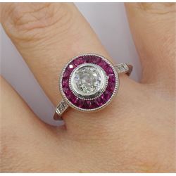 Platinum target design ruby and diamond ring, old cut central diamond of approx 0.50 carat,, with calibre cut ruby surround and diamond set shoulders 