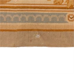 20th-century Aubusson-style woven tapestry wall hanging of rectangular form, the design with a central oval floral medallion composed of delicate sprays in soft pinks, creams, and muted green enclosed by an elaborate dark blue scrolling acanthus ground enriched with foliate ornamentation, field framed by floral cartouches to the corners and multiple guard borders in pale blue, ivory, and ochre tones