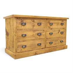 Indigo Furniture - large rustic oak chest, rectangular top fitted with six drawers with metal pull handles, on skirted base