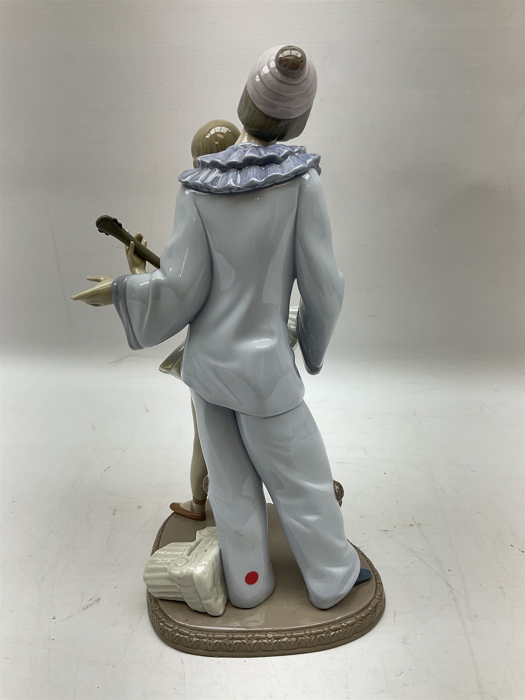 Lladro figure, Minstrel's Love, modelled as a couple entertaining, the lady in ballerina costume playing the lute and the gent stood behind her in jester type dress, sculpted by Rafael Lozano, with original box, no 5821, year issued 1991, year retired 1993, H31cm