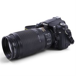 Nikon D90 DSLR camera body, serial no. 8230680, with a Nikon ED AF-S Nikkor 70-300mm 1:4.5-5.6 G lens, serial no. 3102829, with battery and Nikon Quick Charger, in carry case with other accessories including hoods, caps and filters