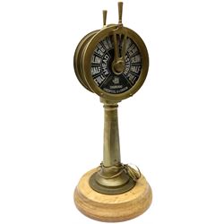 Early 20th century, illuminating brass ship's telegraph by Chadburns of Liverpool and London, on a circular wooden plinth, H55cm