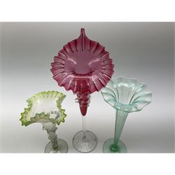 A Victorian Vaseline glass trumpet vase, with crimped rim and trailed frilled decoration, H26cm, together with a 20th century example, and a Victorian cranberry glass Jack-in-the-pulpit vase. (3). 