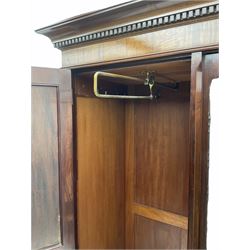 Early 20th century mahogany wardrobe, projecting dentil cornice over central bevelled mirror and two panelled doors, the interior fitted with hanging space and shelf