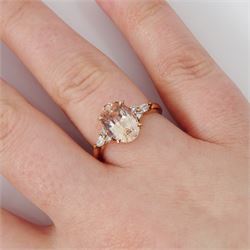 14ct rose gold pink / peach sapphire and diamond ring, single oval cut sapphire of 3.07 carat, with two round brilliant cut diamonds and a pear cut diamond set either side, stamped, total diamond weight 0.11 carat, with Gem Lab report