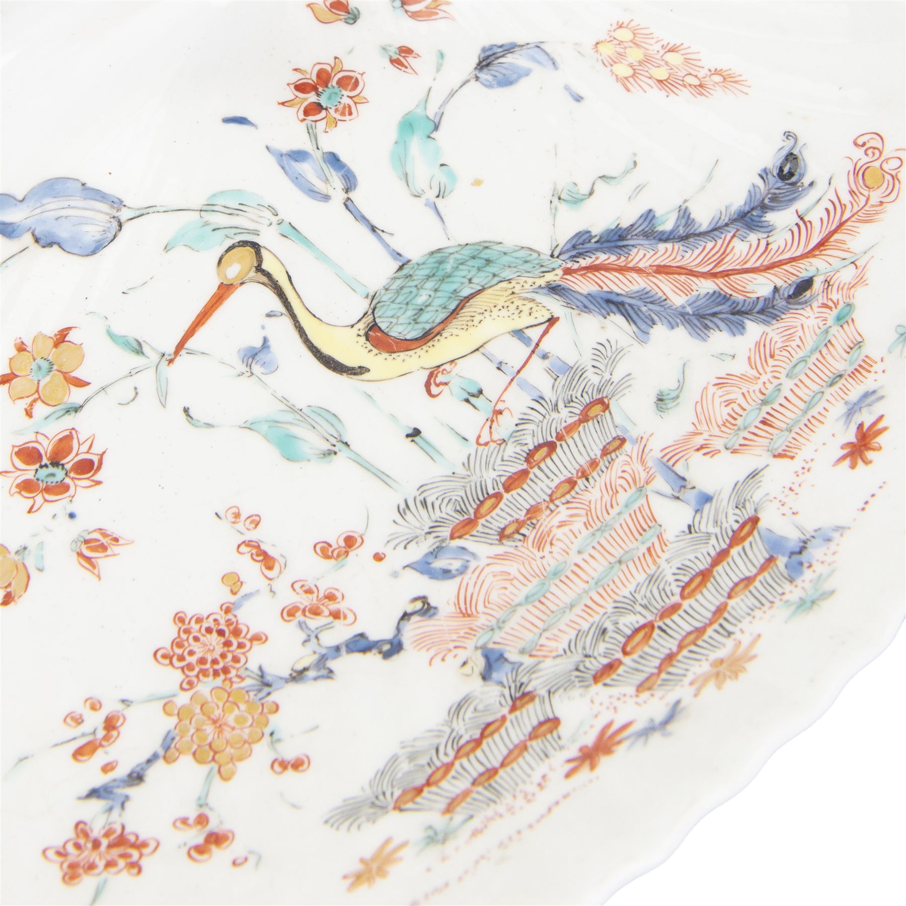 18th century porcelain dish, attributed to Chantilly, circa 1740-1750, with later ormolu mounted handle and feet, the dish of moulded shell form, painted in the Kakiemon pallet with an exotic bird and grasshopper amidst flowers and foliage, with foliate ormolu handle, and upon three scrolling foliate feet, possible obscure Chantilly mark beneath, including handle H10cm W31cm

A letter from the Ashmolean Museum accompanied the dish when it entered the current vendor's family collection. In the letter, Dr. Impey noted that the painting is European, possibly Dutch. The general consensus was that the shell dates to the 18th century, with the ormolu mounts likely added in the 19th century. However, the factory of origin remained unidentified. The letter was signed by Ian Lowe in 1974. Further consultation at the time with four members of staff at the Victoria and Albert Museum yielded differing opinions, with suggestions including Chantilly and Bow. The piece has been attributed to Chantilly partly due to what appears to be a partially obliterated horn motif beneath.