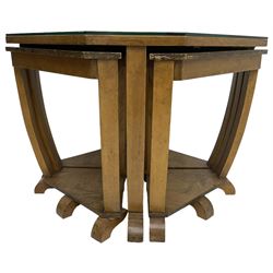 1930s Art Deco period walnut nest of tables, square canted top with segmental figured veneers forming flowerhead with birdseye maple centre, with four smaller nesting tables on arched supports united by undertier, on block feet