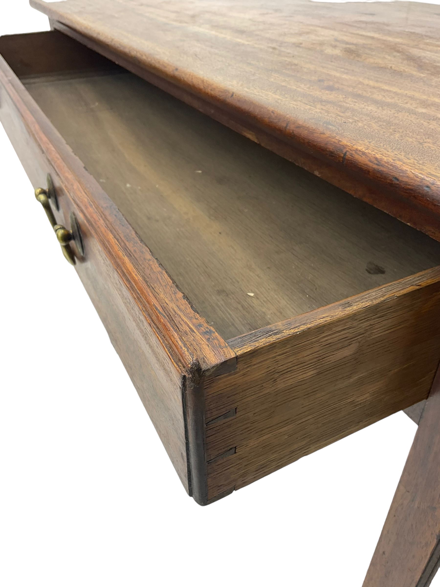 Early 20th century oak side table, rectangular top with rounded edges over single frieze drawer with brass pull handles, raised on square supports