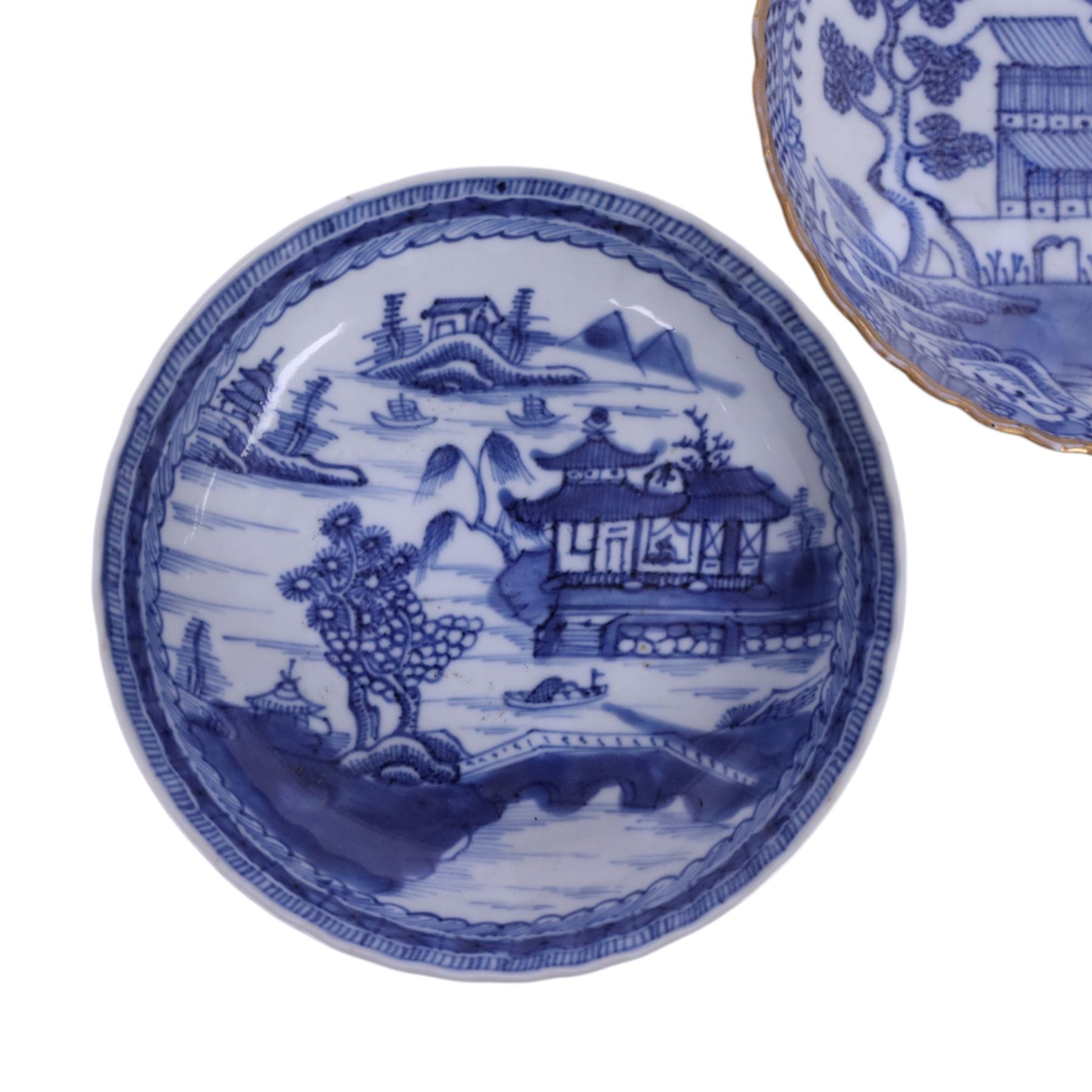 Two 19th century Chinese blue and white tea bowls, each decorated with traditional landscapes, together with two similar saucers, tea bowl H5cm, D9cm  