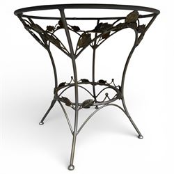 Wrought iron garden dining table with leaf decoration, and set of four matching chairs