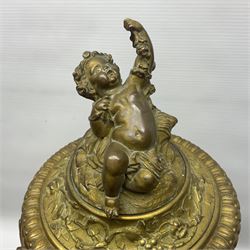 Pair of 19th century French gilt bronze wine coolers, modelled as urns with entwined fruiting vine handles and adorned with Dionysus masks, beneath a frieze depicting putti, the domed covers surmounted by recumbent putto, each upon naturalistically modelled stem and base detailed with basket of grapes and two putto at play, overall H51cm