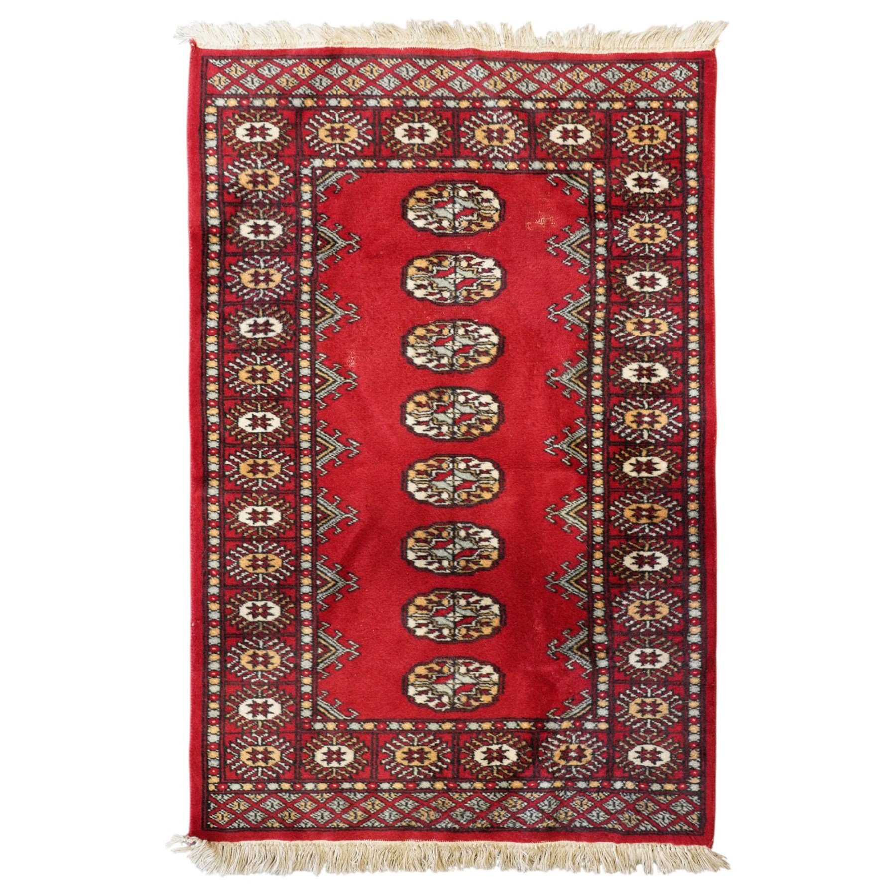 Afghan Bokhara crimson ground carpet, the field decorated with eight Gul motifs with surrounding geometric woven guard bands