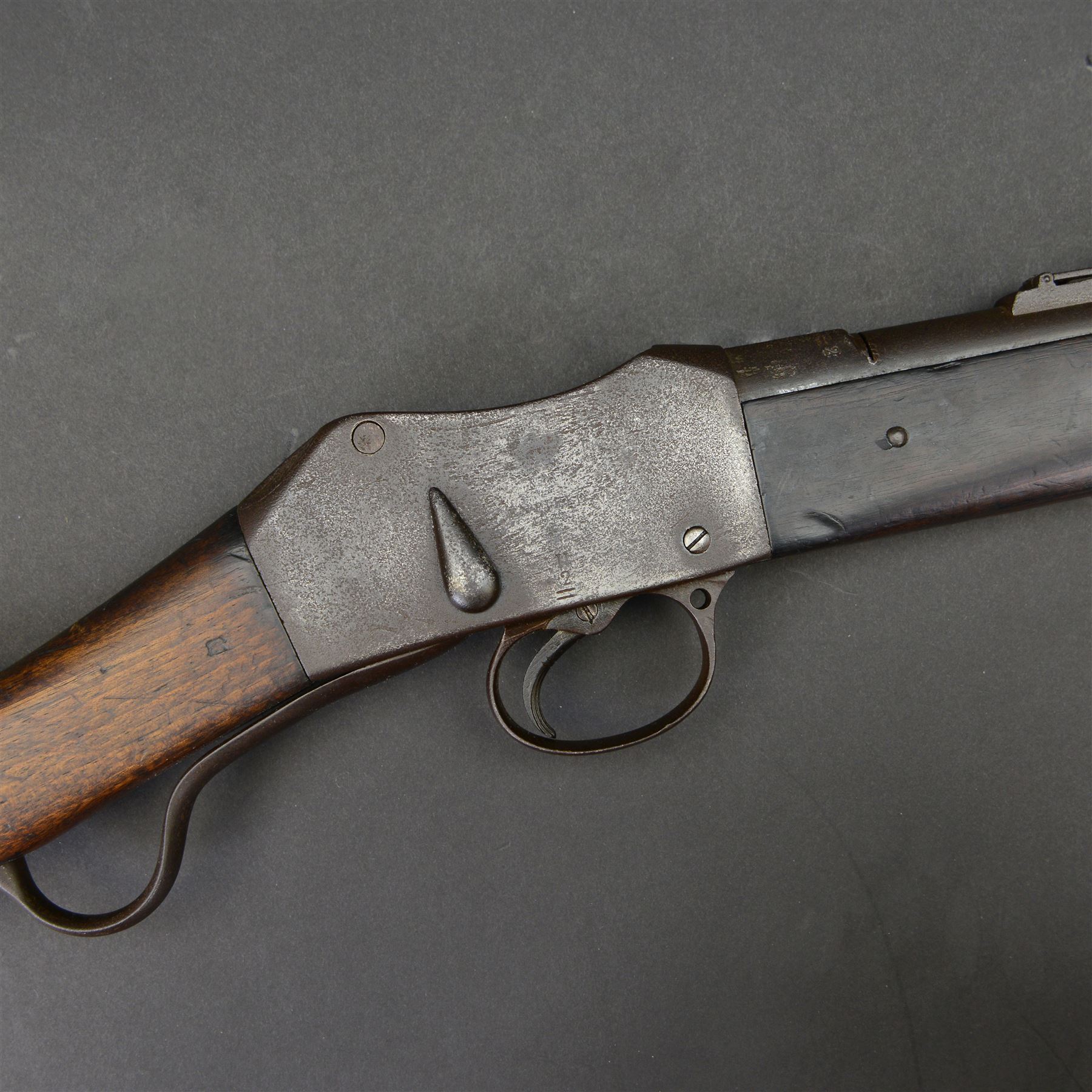 Martini-Henry MKII/2 Carbine, the 52cm round barrel with various inspectors marks,   fitted with ladder sight, with various inspector's marks, the action marked Enfield, the walnut full stock with two steel barrel bands, the butt inset with brass roundel stamped' 12 1893 V 1 GR. A 6', and with Sold Out of Service arrows to the butt, action and barrel, steel cleaning rod beneath, overall 96cm
Sold as an exempt item under Section 58 (2) of the 1968 Firearms Act, to be held as a curiosity or ornament


