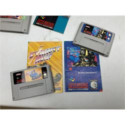 Two Super Nintendo Entertainment System (PAL) controllers, accessories and games. Super NES Game Commander with original box and instruction booklet, Super NES Nintendo Scope (1992) transmitter gun, receiver, Super NES Nintendo Scope 6 game with original instruction booklets. Further games to include ‘The Legend of Zelda a Link to the Past’, ‘Super Mario World’, ‘Super Mario Kart’, ‘The Lawnmower Man’, and ‘Exhaust Heat’, all with original instruction booklets. ‘PowerMonger’ and Disney’s ‘Aladdin’ game cartridges only 