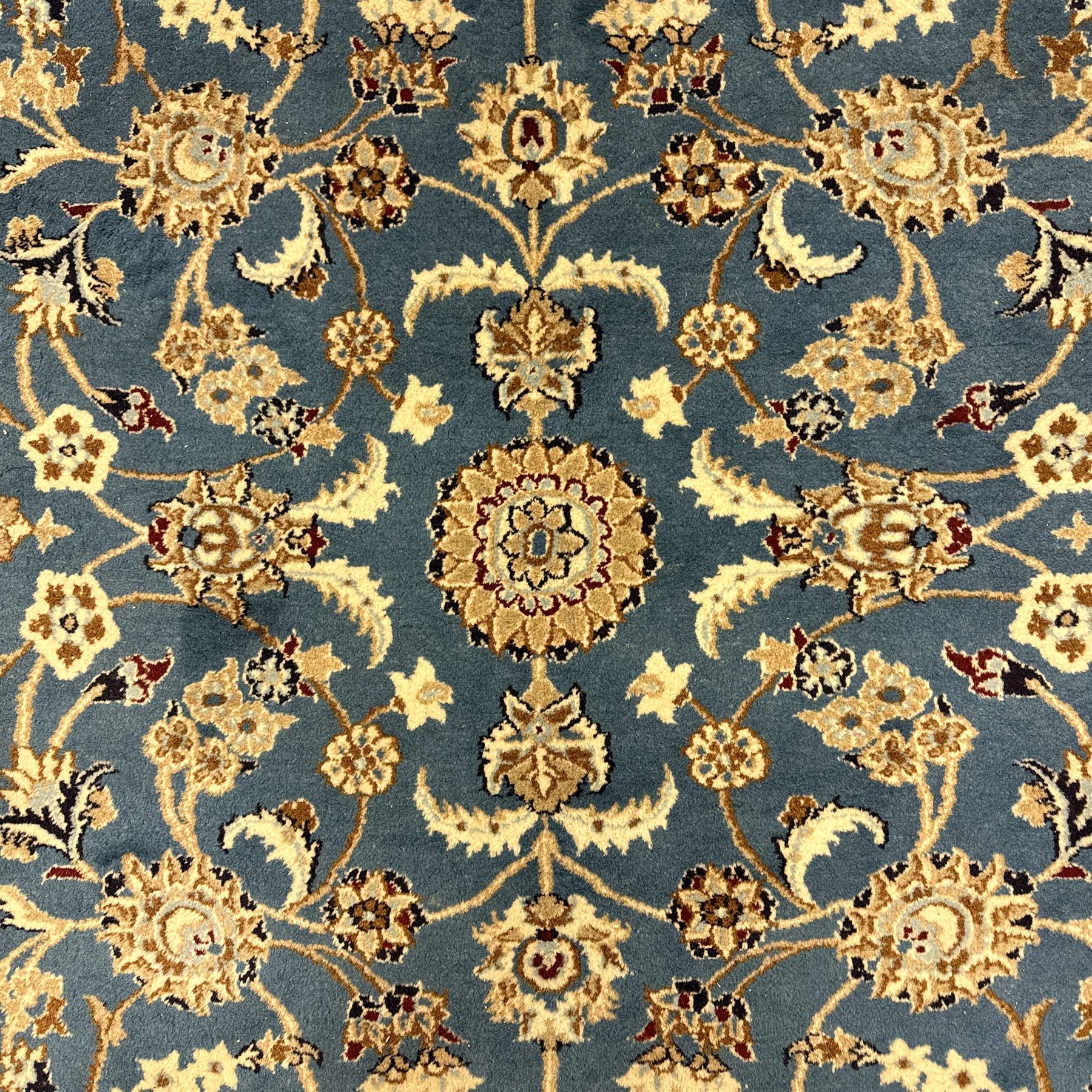 Central Persian Kashan rug, densely knotted, in a teal and cream ground, central medallion with circular rosette surrounded by a highly detailed field of radiating palmettes, vine arabesque patterns, rosettes, and  lotus blossoms, main border with alternating palmettes flanked by two narrower guard borders with a repeating floral meander design 