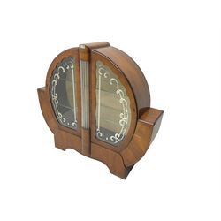 Art Deco walnut display cabinet, of circular design, fitted with two shaped glazed doors enclosing two glass shelves, flanking five glass rods