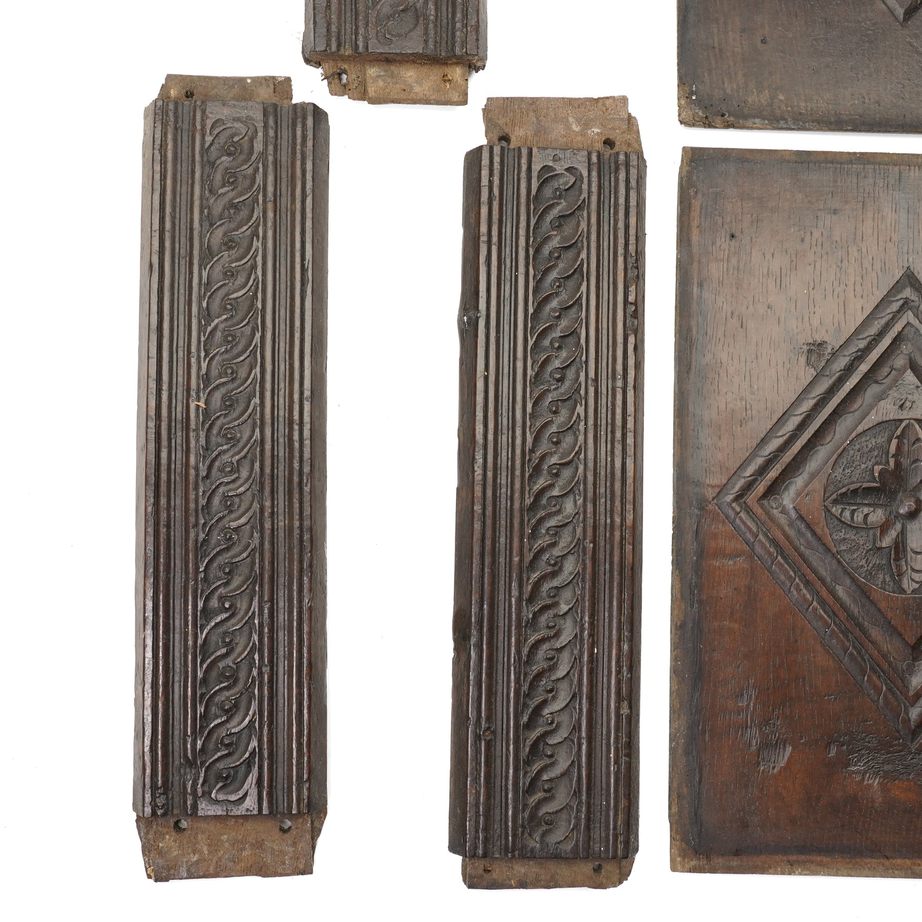 Set of four 17th century carved panels with lozenge decoration, and three further carved panels, lozenge panels approx 36.5cm x 24cm, three further 35cm x 10cm 