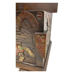 Mid-20th century carved hardwood chest, the rectangular hinged top with decorative strap hinges, the front and sides deeply carved with medieval-style jousting knights, heraldic shields, and architectural elements, raised on shaped block feet