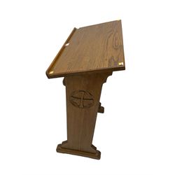 20th century ecclesiastical oak lectern, the sloped rest on moulded end supports with carved decoration, the front panelled with Gothic style carved and pierced tracery, on sledge feet