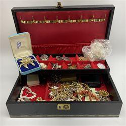 Collection of costume jewellery in a black jewellery box, coral necklace, decorative brooches etc.    