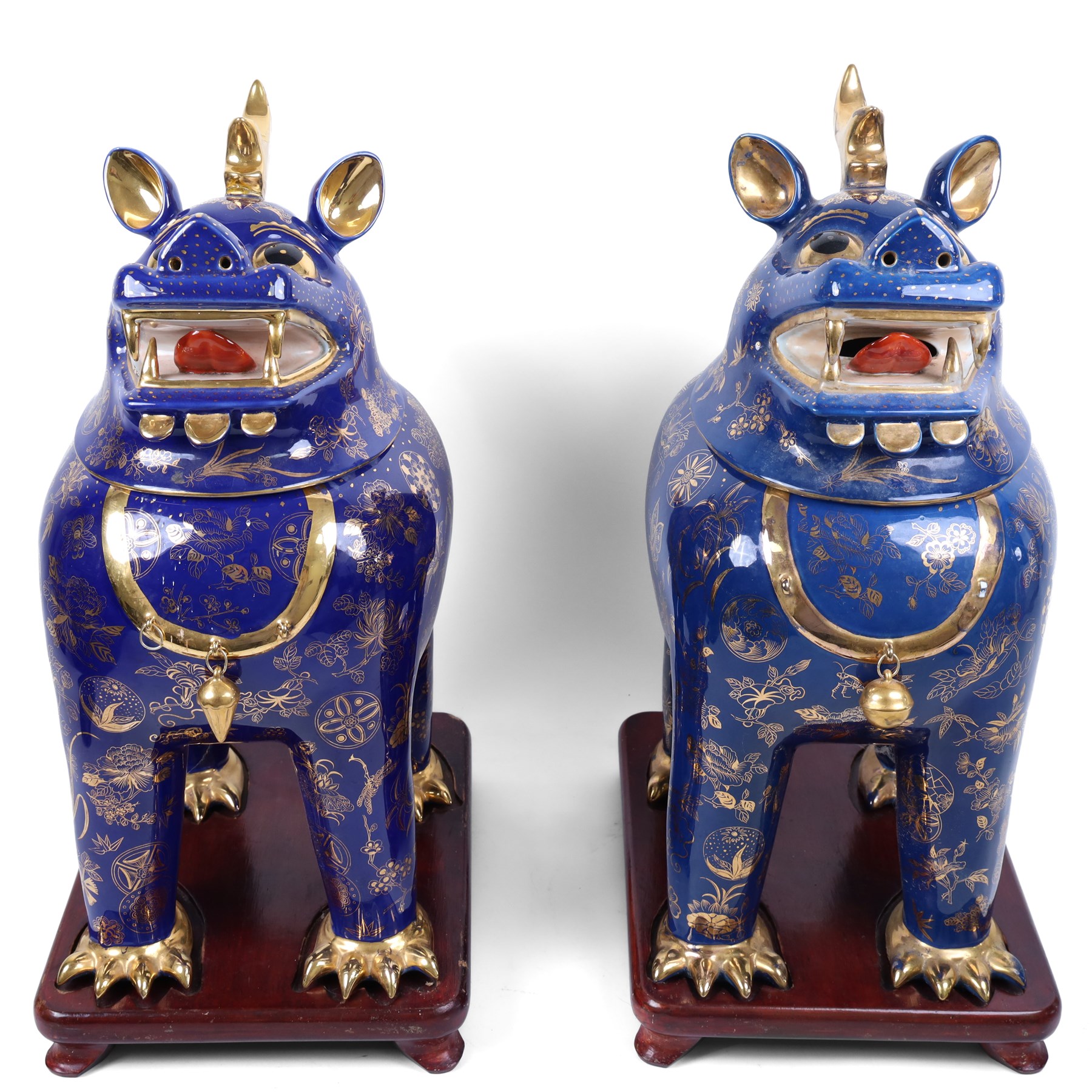 Pair of 20th century foo dog incense burners, decorated with gilt flowers and insects upon a blue ground, on wooden stands, H58cm 