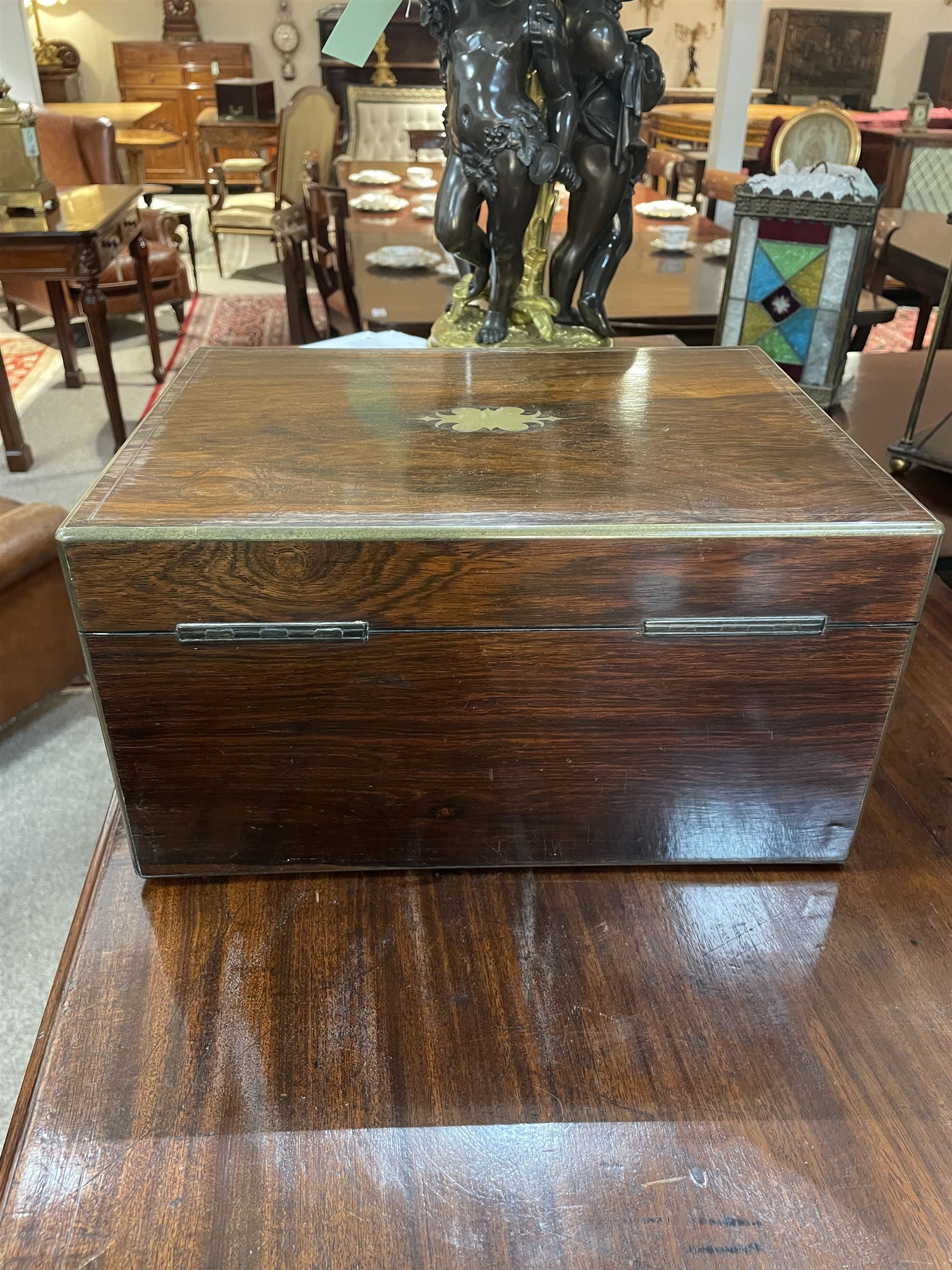  Victorian brass inlaid rosewood dressing table box, retailed by F.L. Hausburg, Liverpool, the lid centred by a brass cartouche, opening to reveal letter store to lid underside, above a fitted interior, with ten mounted cut glass jars, bottles and manicure set, within lift out leather trays, above jewellery drawer, with key, H17cm D24cm