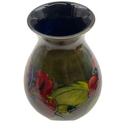 Moorcroft vase of bulaster form, decorated in Hibiscus pattern upon a green ground, H21cm 