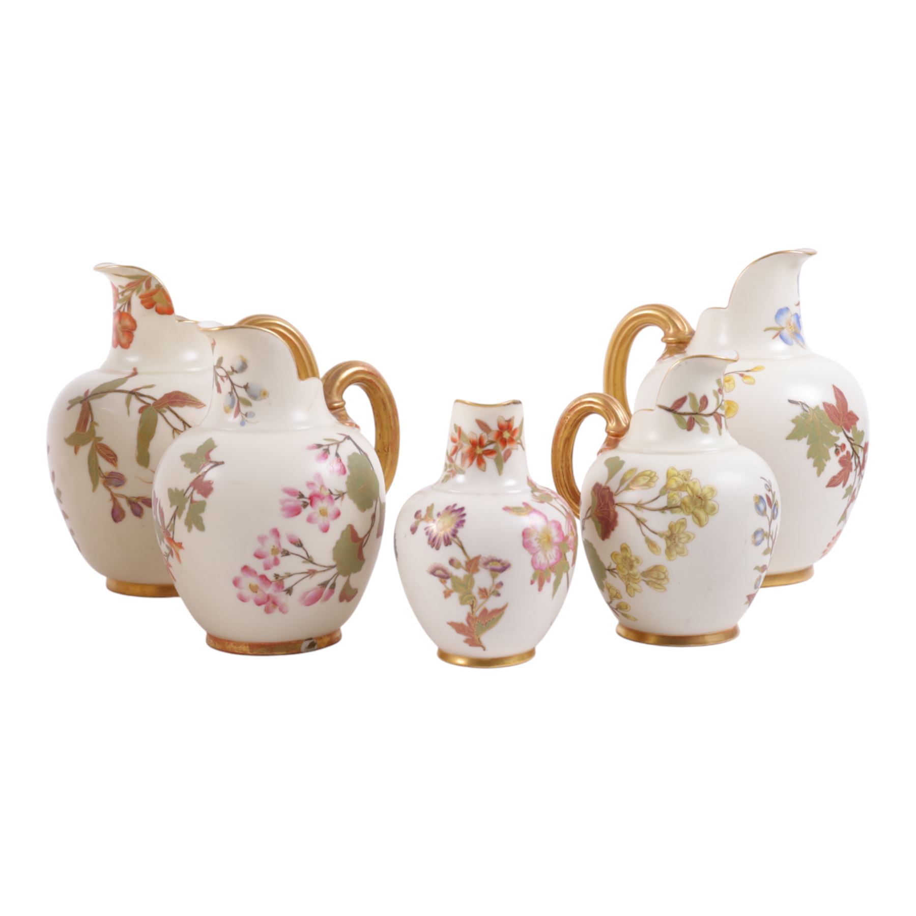 Five Royal Worcester Blush Ivory jugs, shape 1094, each decorated with floral sprigs and with gilt handles , all with puce mark to base, tallest H18cm