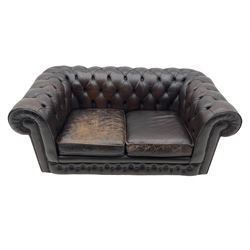 Chesterfield two seat sofa, upholstered in distressed brown buttoned back leather
